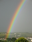 27073 Bright rainbow over green fields and white houses.jpg